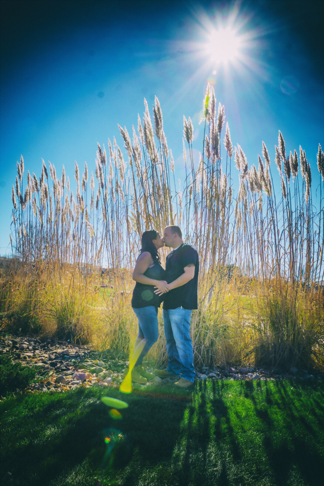 A couple at golden hour in tall autumn grass